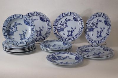 several blue and white plates are stacked on top of each other