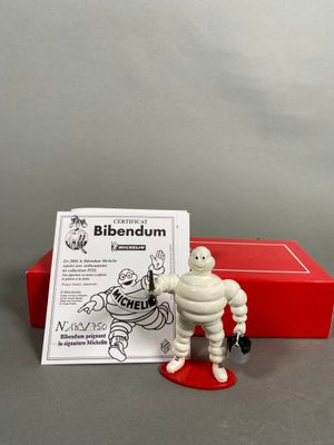 the figurine is sitting next to a red box