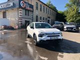 a white suv parked in front of a building