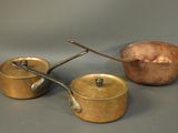 three pots and pans sitting on a table
