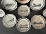 nine plates with different designs on them on a table