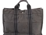 an image of a gray tote bag sitting on top of a white surface
