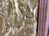 a gold statue of a man and a woman on a horse