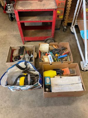 many boxes of tools sitting on the floor in the garage