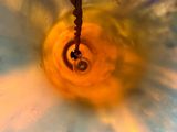 a picture of a sink that has a yellow and blue flower in it