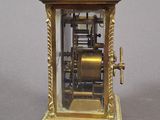 a gold clock that is sitting on a table