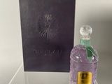 the perfume bottle is next to the box on the table