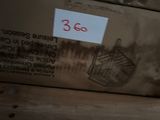 a bird cage on top of a box with a price tag on it