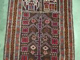 an old rug with a design on it on a green floor