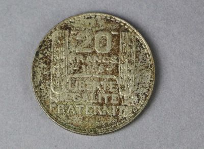 a close up of a coin on a table with a white background