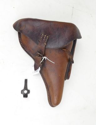 an old leather holster with a key in it on a white surface