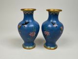 pair of blue vases with birds and flowers painted on them