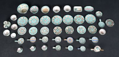 many different types of pottery on a black surface