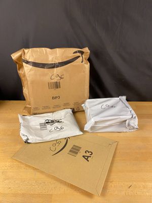 a brown bag of food sitting on a table next to a bag of food