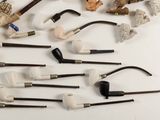 many different types of smoking pipes on the table