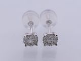 a pair of diamond earrings on a white background