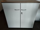 a white cabinet with two doors and a brown counter top