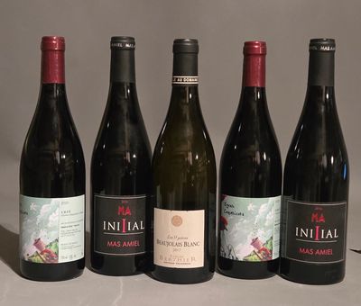 several bottles of wine are lined up on a table