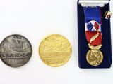a medal and a coin sitting next to each other