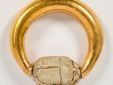 an image of a gold ring with a scarveil inside of it
