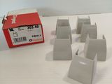 five pieces of white plastic sitting on a white surface