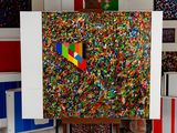 a picture of a painting on a easel with a lot of confetti sprinkles on it