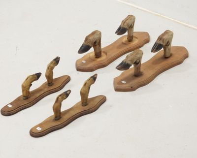 four wooden ducks are sitting on a wooden stand