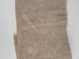the towel is tan and has a paisley pattern on it