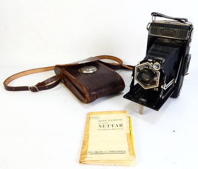 a camera and a book sitting on a table