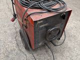 an image of a welding machine sitting on top of a cement floor
