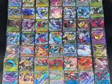a large collection of pokemon cards sitting on top of a table
