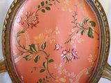 a pink chair with a floral design on it