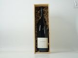 une bouteille de vin dans un coffret en bois sur une table