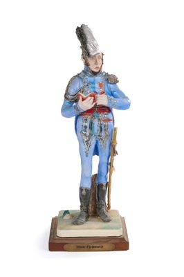 figurine of a man in a blue uniform holding a cane