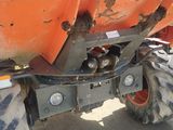 a tractor that is parked next to a dump truck