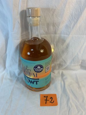 a bottle of liquor on a table with a price tag