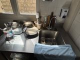 a kitchen sink with a lot of dirty dishes on it