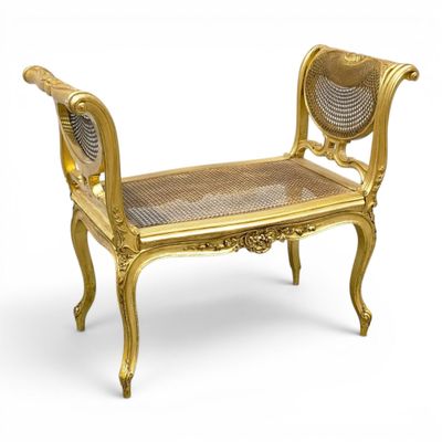 an image of a gold bench with wicker seat on a white background
