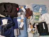 a lot of clothing that is sitting on a table