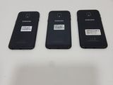 three black samsung phones sitting side by side on a white surface