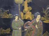 painting of two women sitting on a bench with a dragon in the foreground