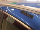 a sticker on the roof of a car that says pluto