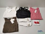 four pairs of shoes, a sweater, a bag, and a pair of flip flops