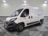 the white van is parked on a checkered floor in a room