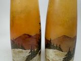 two vases that are sitting on a table