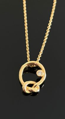 gros plan d'un collier en or sur une surface noire