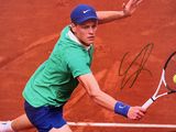 photo dédicacée d'un joueur de tennis en train de frapper une balle de tennis avec une raquette