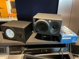 two speakers sitting on top of each other on a table