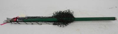 a green umbrella with a black handle on a white surface