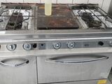 a silver stove top with two burners on it in a kitchen